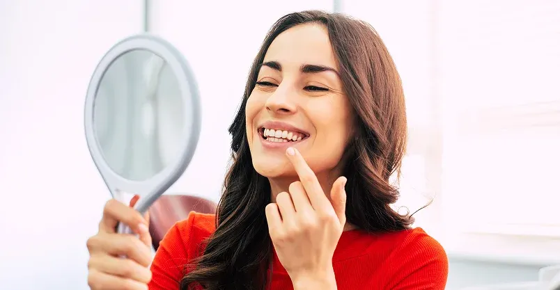 Happy patient pointing to smile
