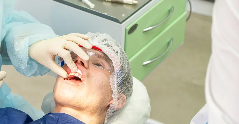 Happy patient pointing to smile