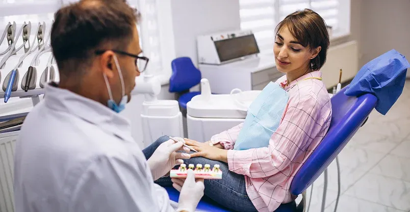 Happy patient pointing to smile